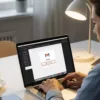 Person using a laptop to access Gmail settings and delete a Gmail account permanently