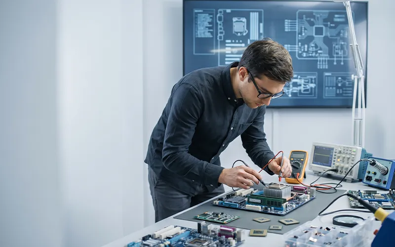 Computer hardware engineer working with computer components and circuit boards